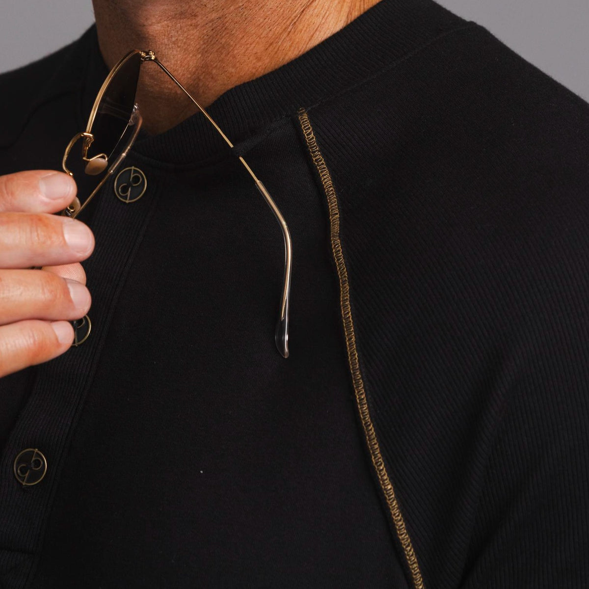 Man modeling a black Short Sleeve Henley shirt