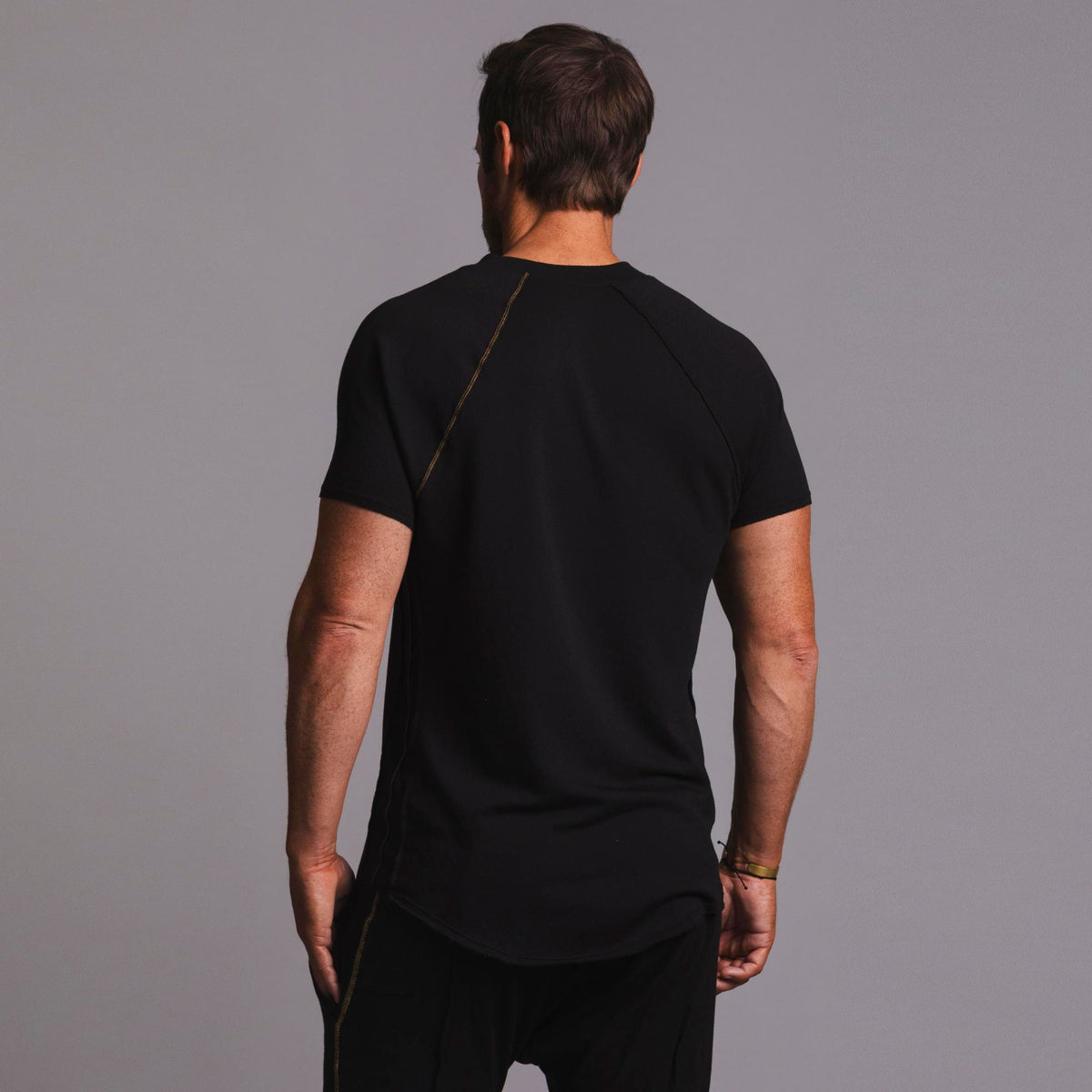 Man modeling a black Short Sleeve Henley shirt