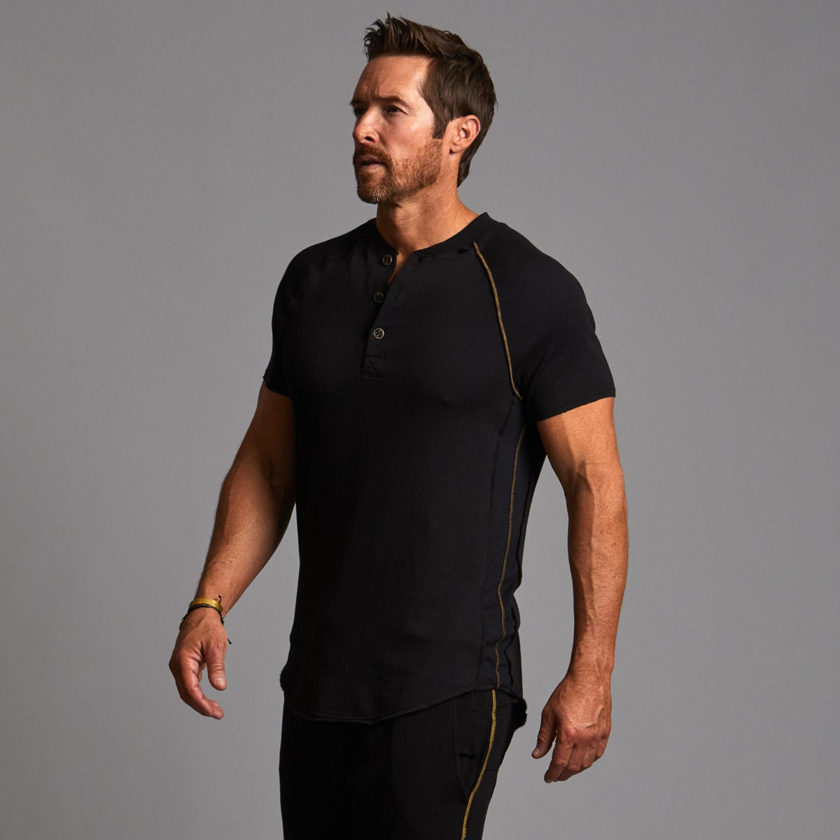 Man modeling a black Short Sleeve Henley shirt