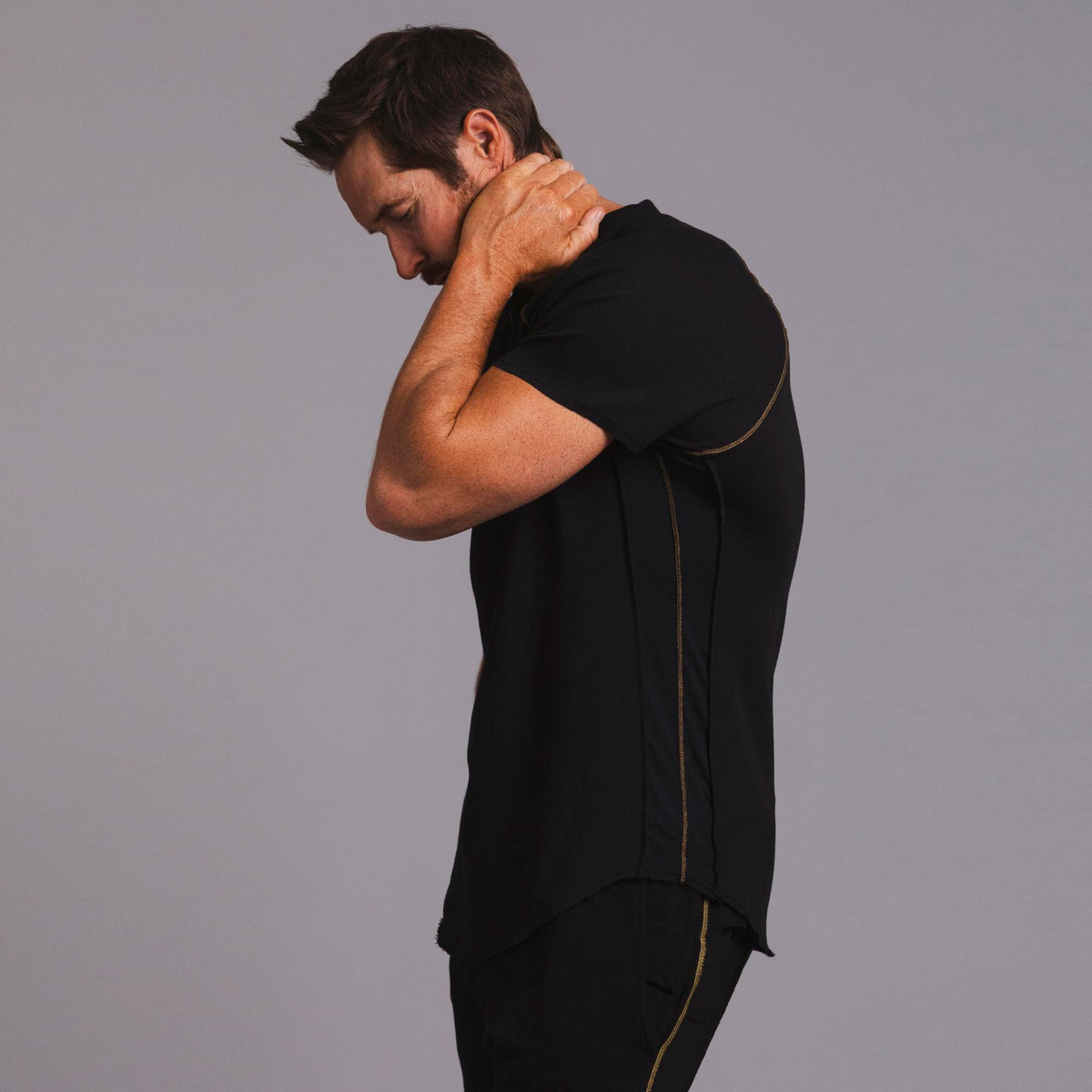 Man modeling a black Short Sleeve Henley shirt