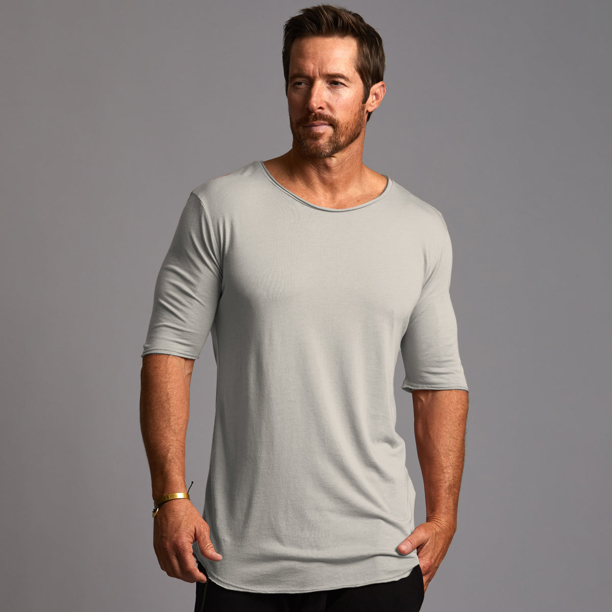 Male modeling grey crew neck shirt