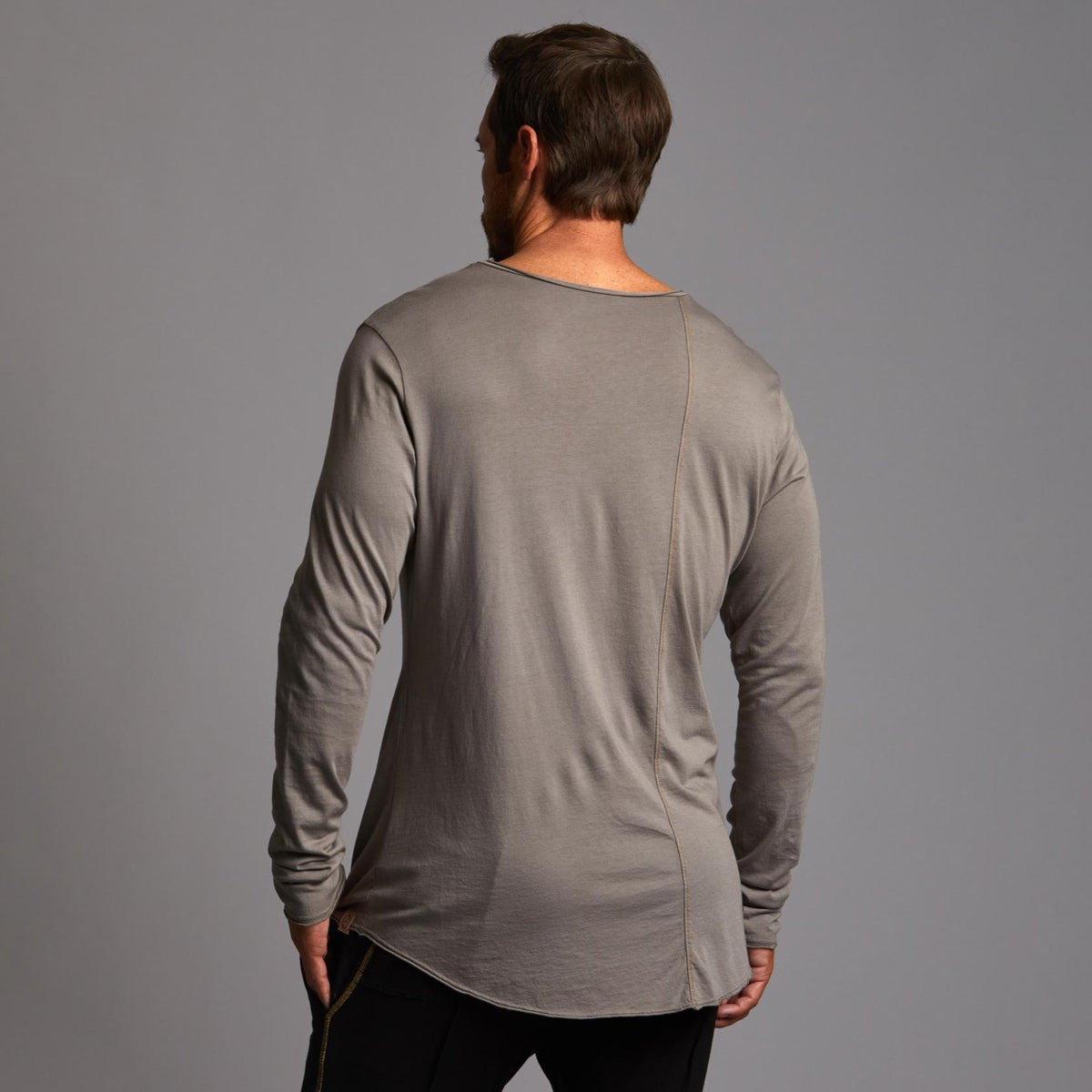 Man modeling a long sleeve crew shirt in deep clay gray