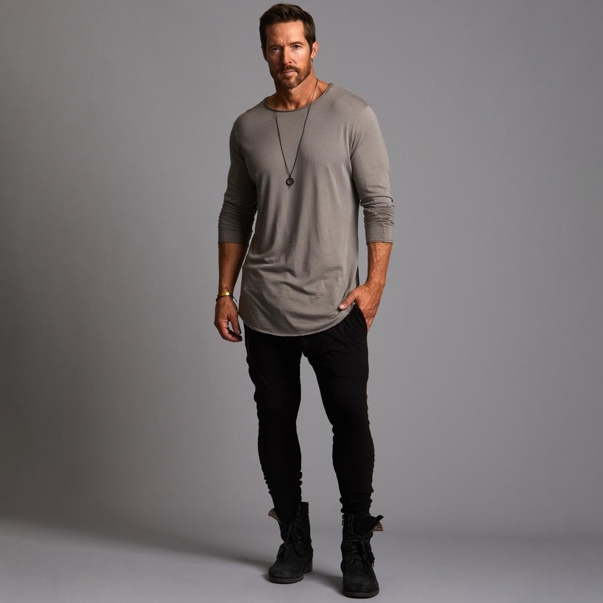 Man modeling a milano pants in black