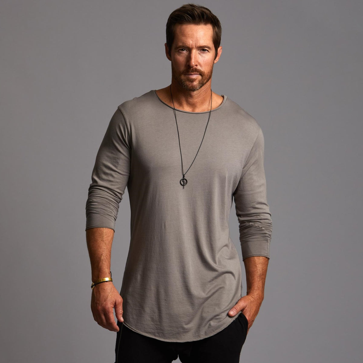 Man modeling a long sleeve crew shirt in deep clay gray