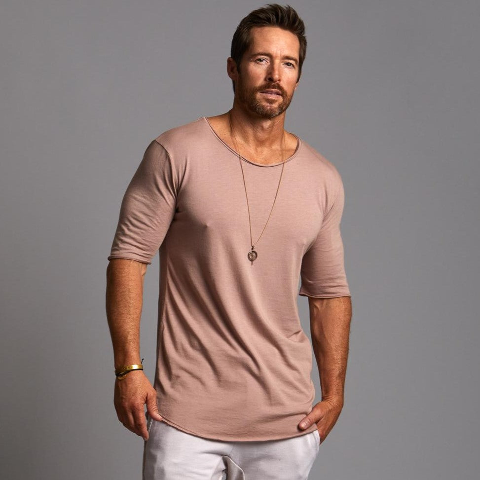 Male modeling light pink crew neck shirt