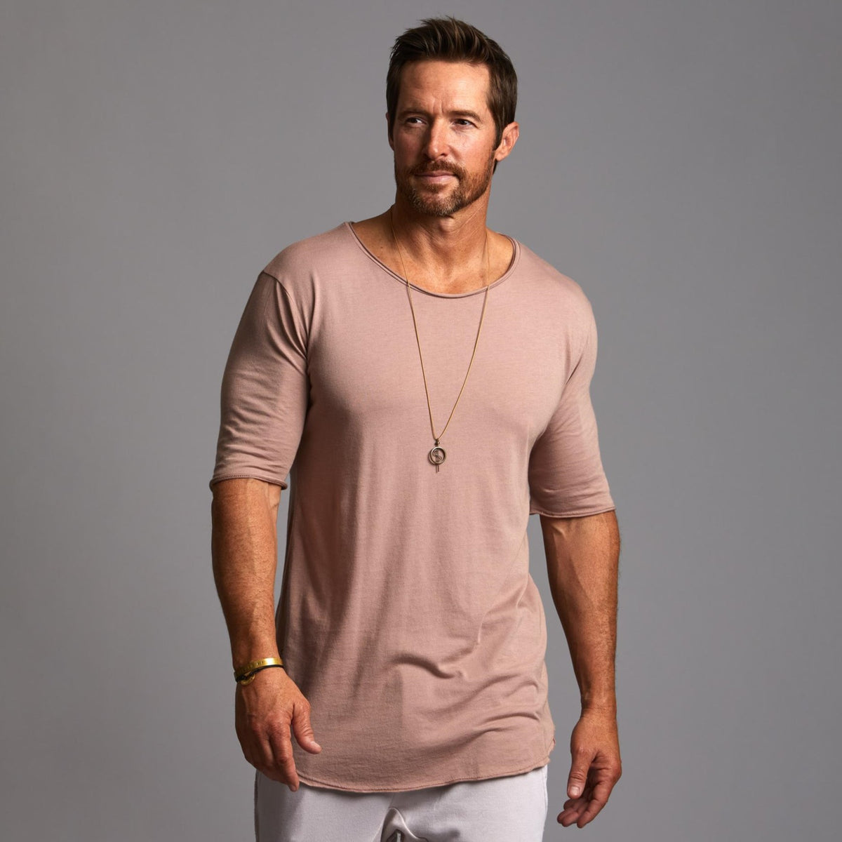 Male modeling light pink crew neck shirt