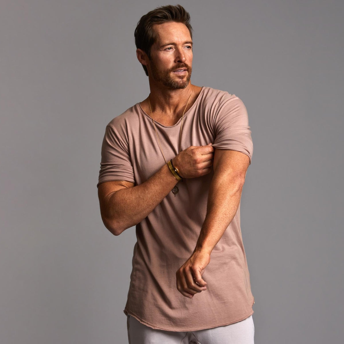 Male modeling light pink crew neck shirt