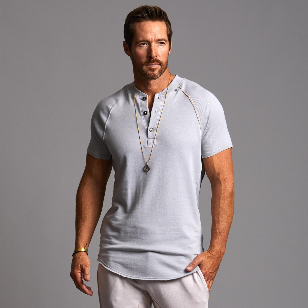Man modeling a Blue Clay colored Short Sleeve Henley shirt