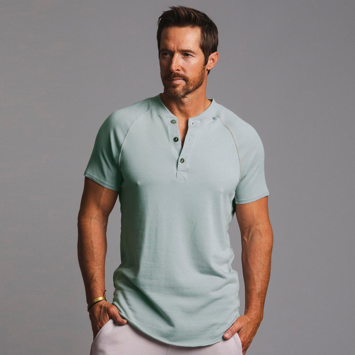 Man modeling a Agave colored Short Sleeve Henley shirt
