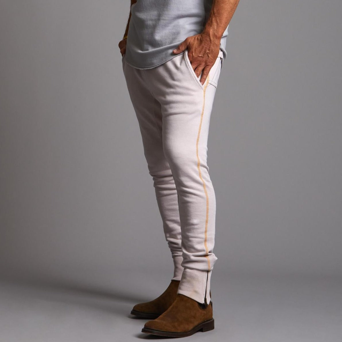 Man modeling the milano pant in white stone