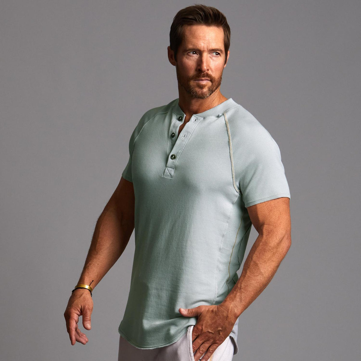 Man modeling a Agave colored Short Sleeve Henley shirt