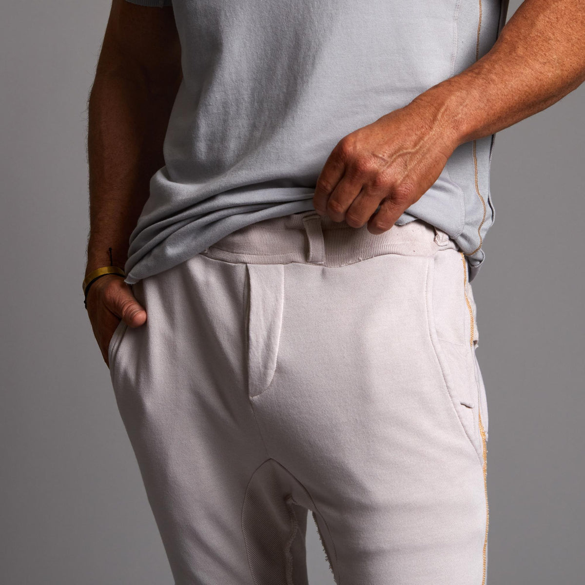 Man modeling the milano pant in white stone
