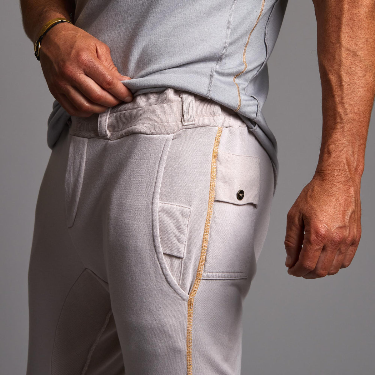 Man modeling the milano pant in white stone
