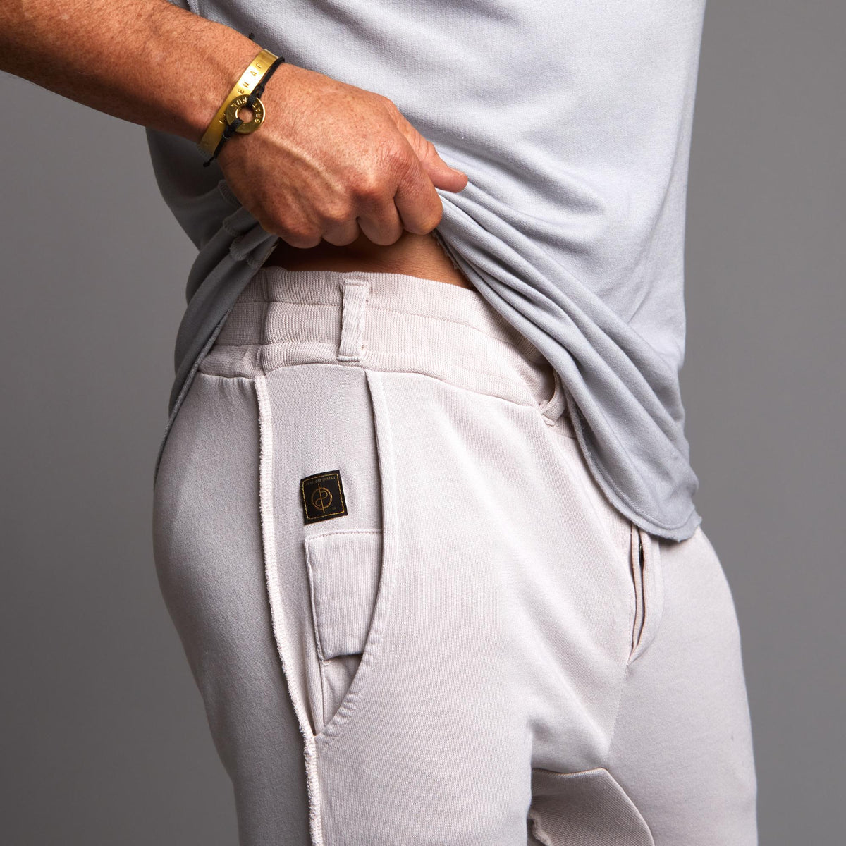Man modeling the milano pant in white stone