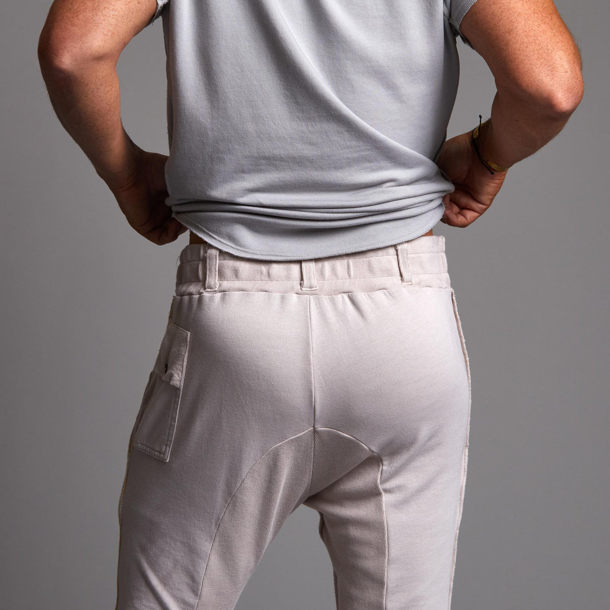 Man modeling the milano pant in white stone