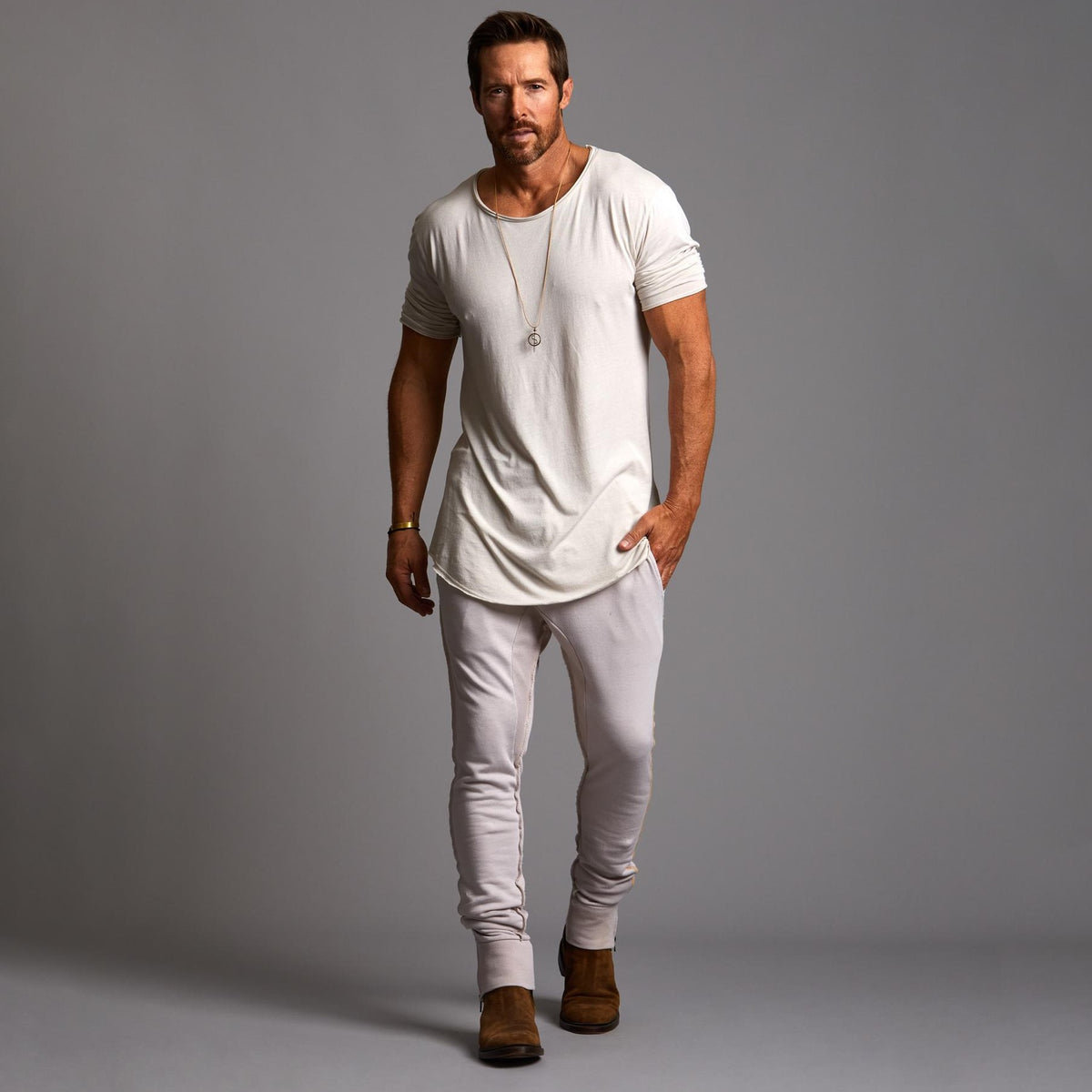 Man modeling a milano pants in white stone