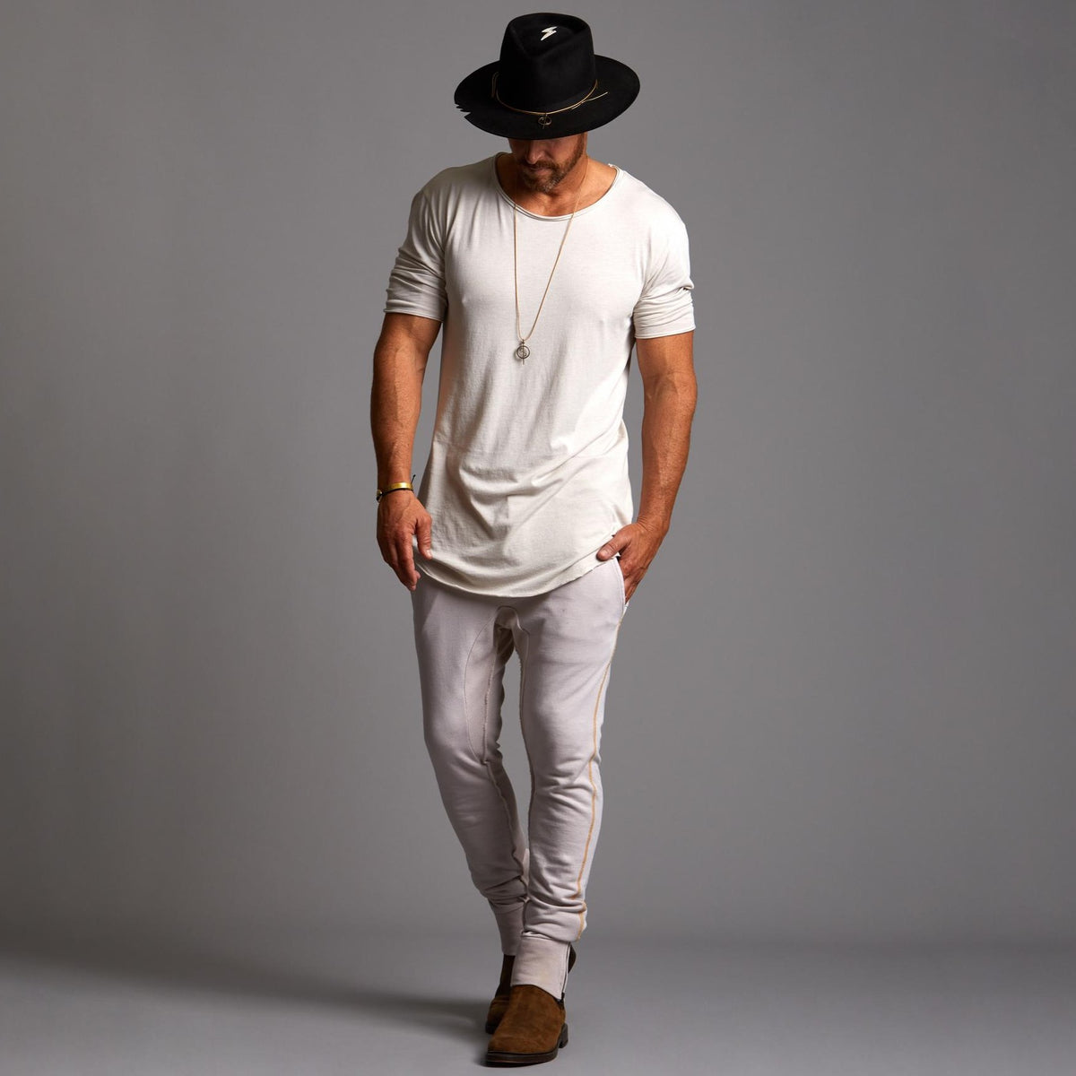 Man modeling the milano pant in white stone