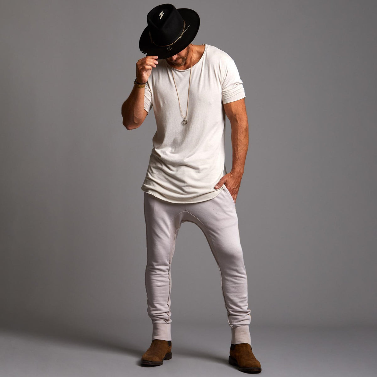 Man modeling the milano pant in white stone