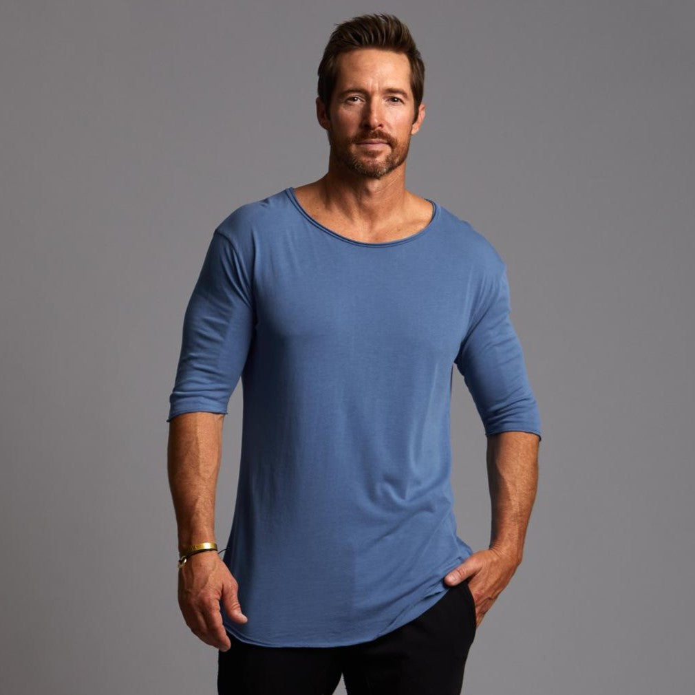 Male modeling blue crew neck shirt