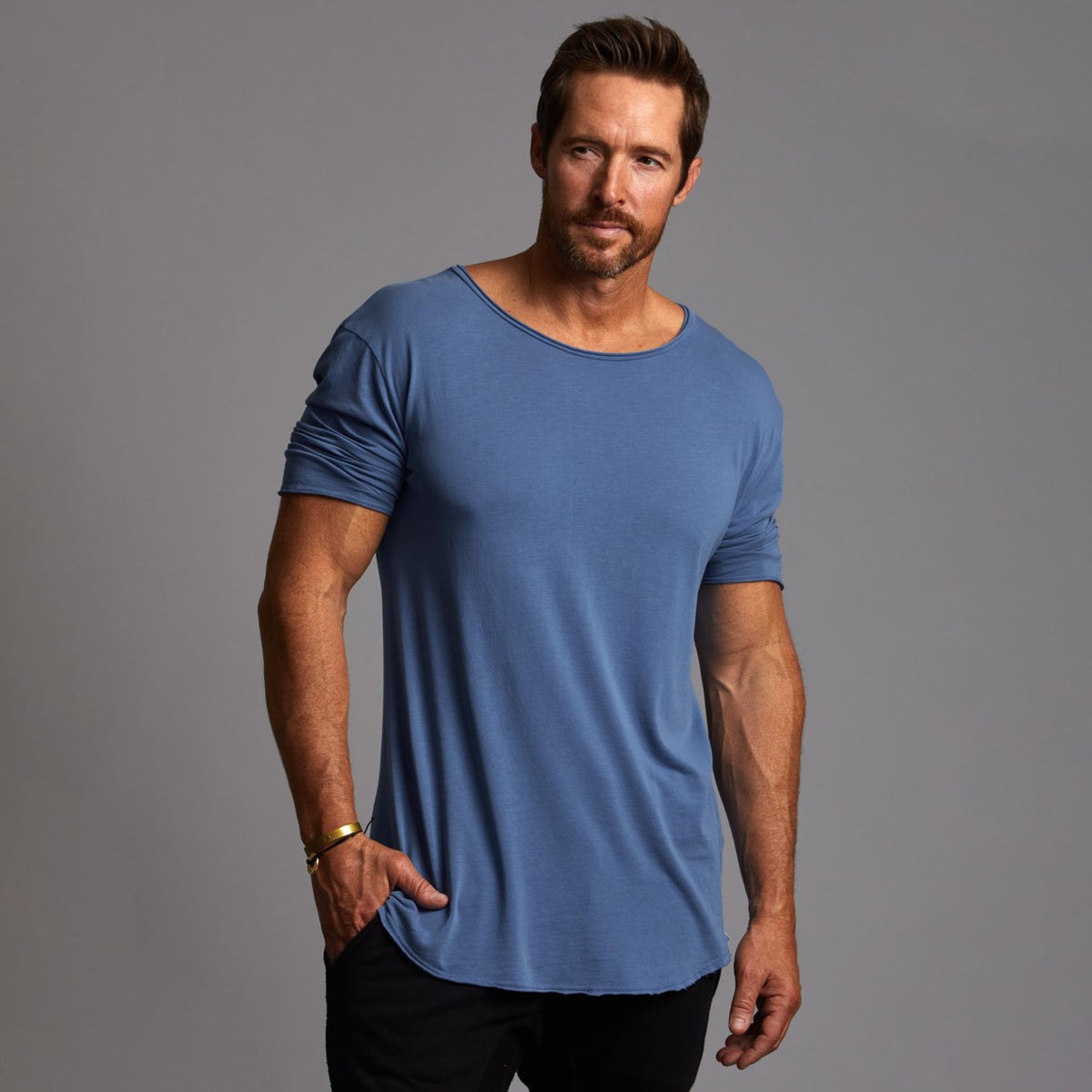 Male modeling blue crew neck shirt