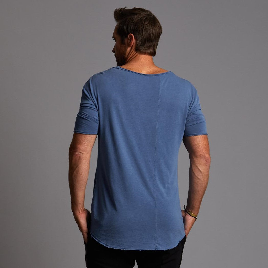 Male modeling blue crew neck shirt