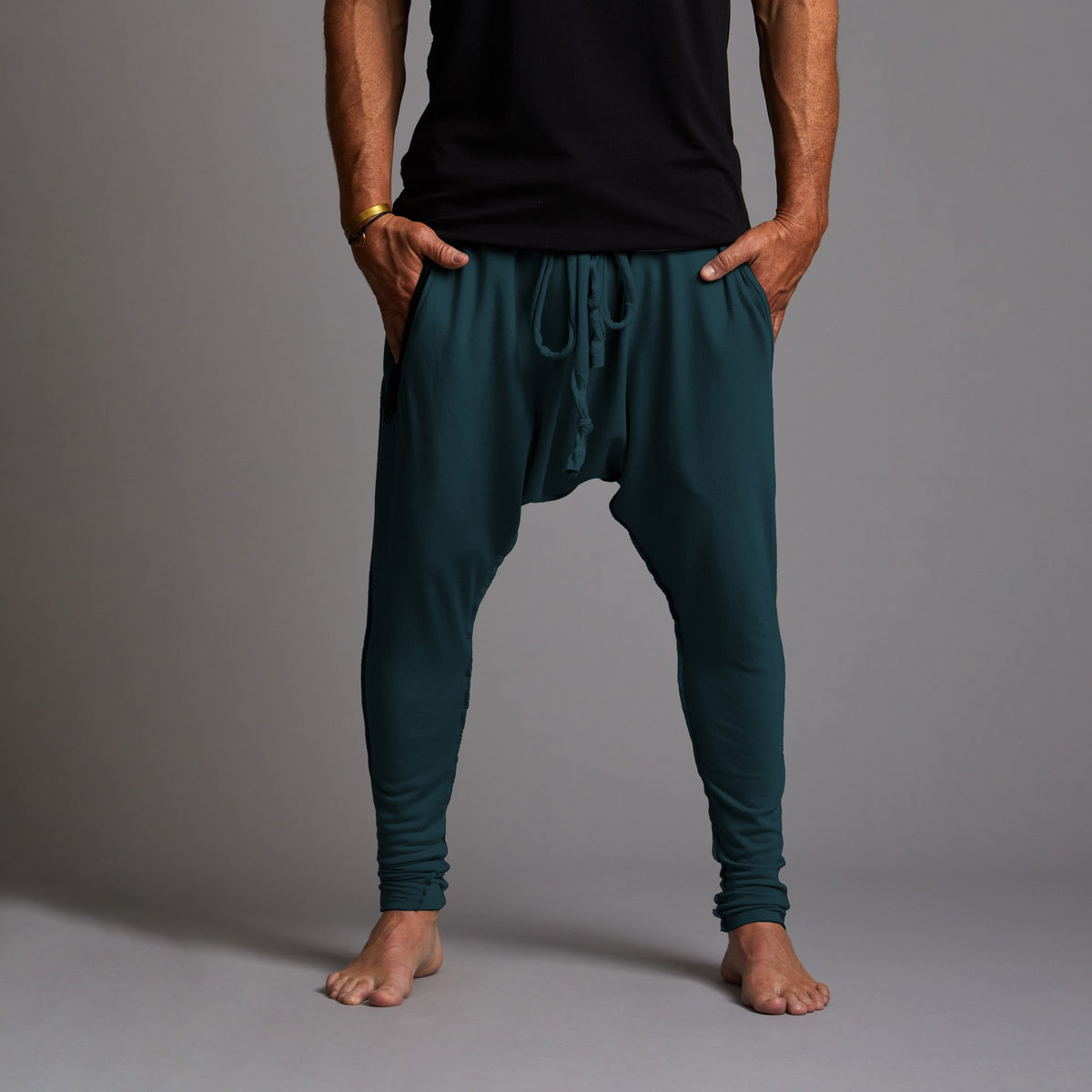 male modeling pants in midnight teal
