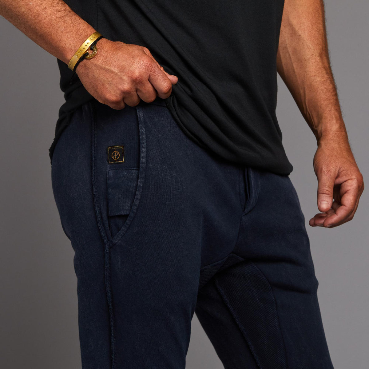Man modeling the milano pant in blue mineral