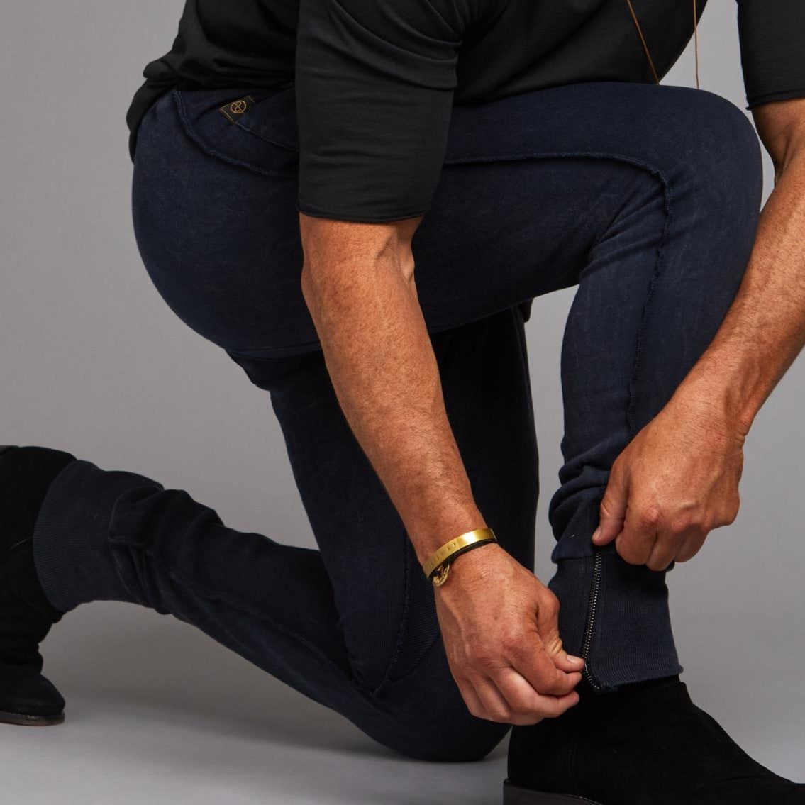 Man modeling the milano pant in blue mineral