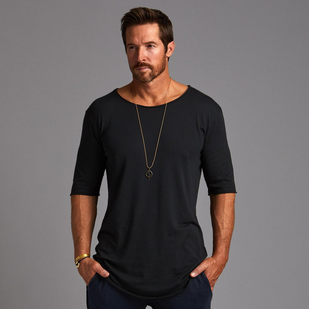 Male modeling black crew neck shirt 