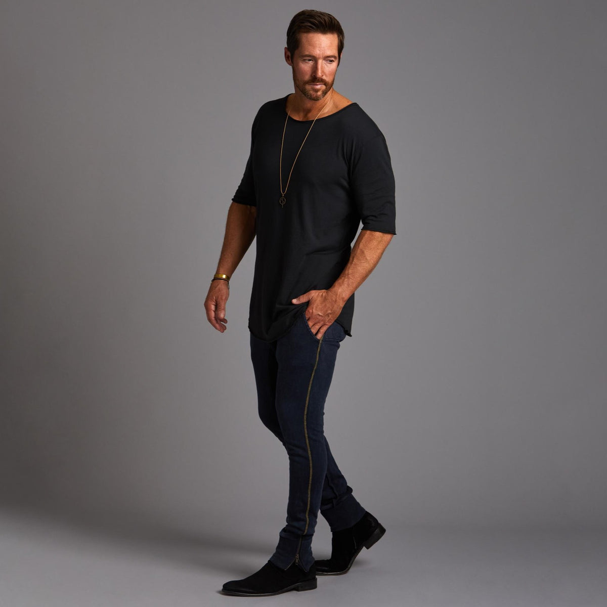 Man modeling the milano pant in blue mineral
