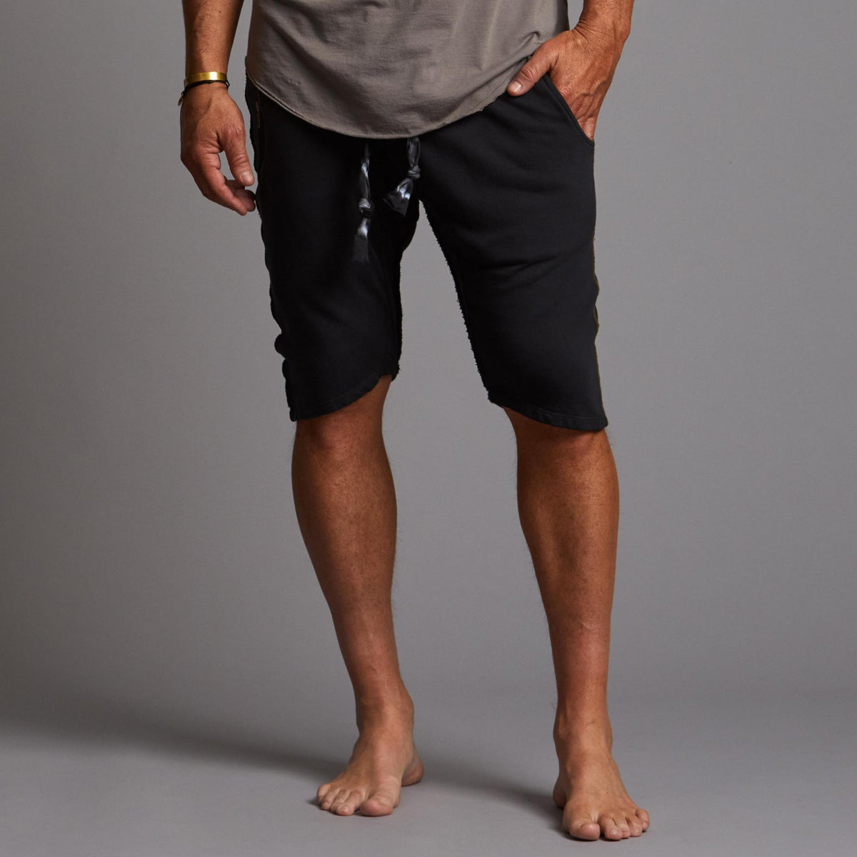 A man modeling charcoal blue milanos mid shorts