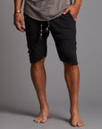 A man modeling charcoal blue milanos mid shorts