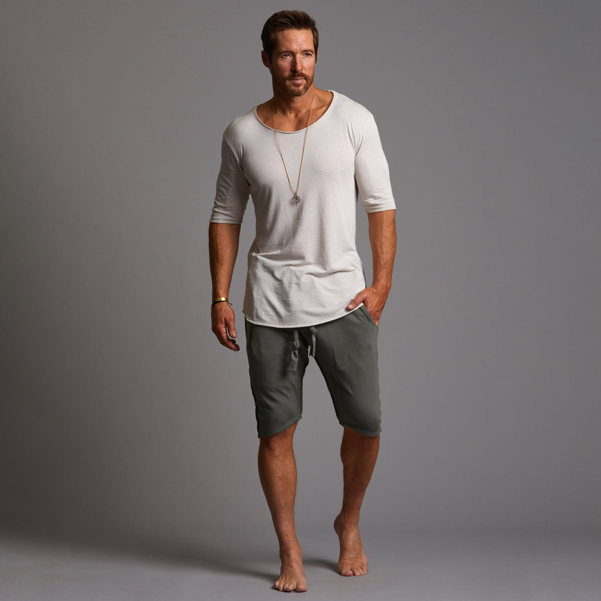 A man modeling urban forest green milanos mid shorts