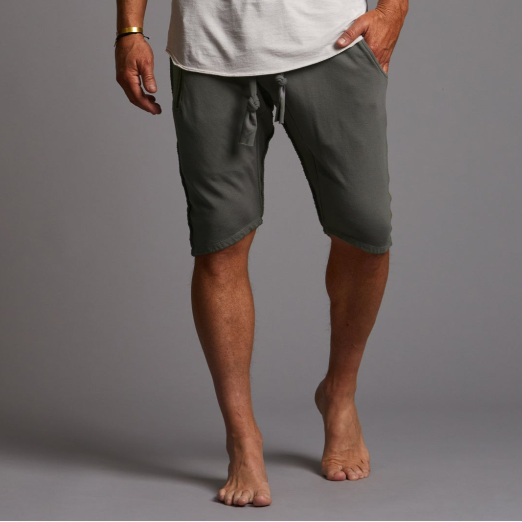 A man modeling urban forest green milanos mid shorts