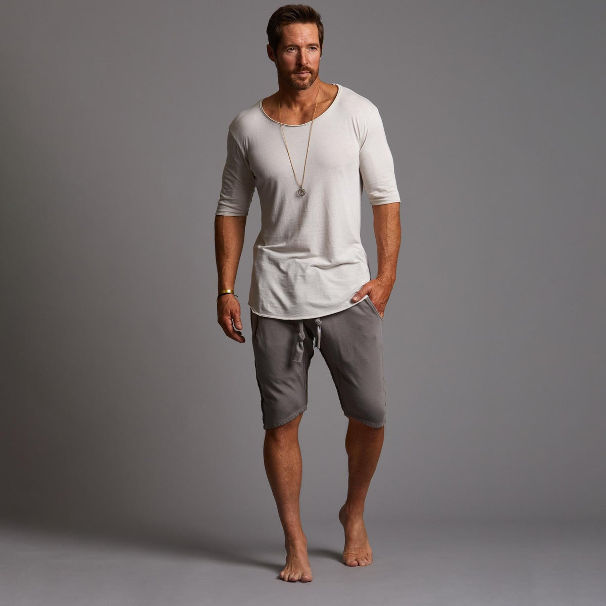 A man modeling deep clay gray milanos mid shorts