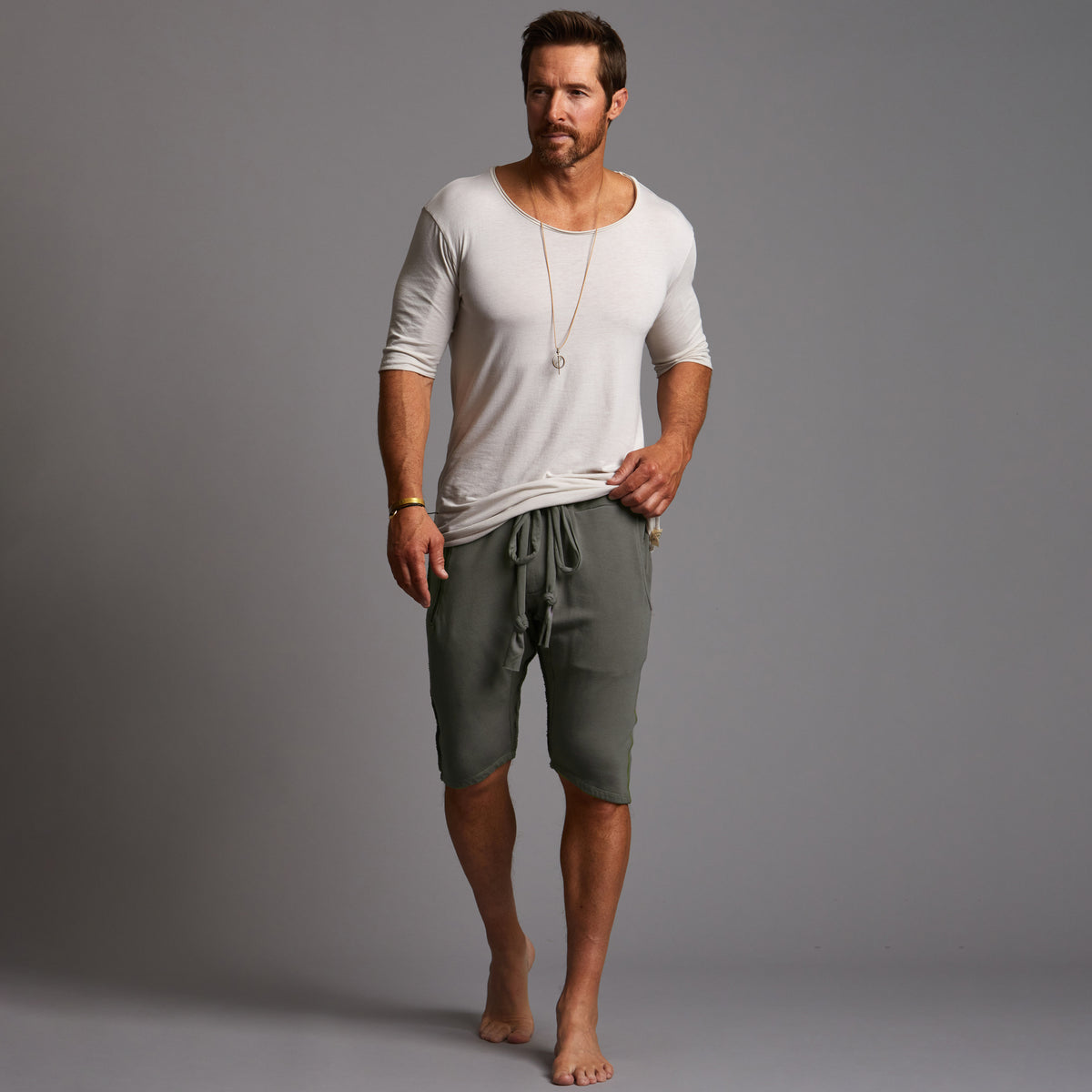 A man modeling urban forest green milanos mid shorts