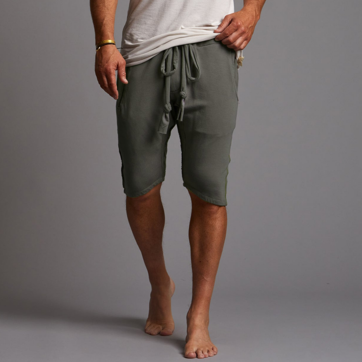 A man modeling urban forest green milanos mid shorts