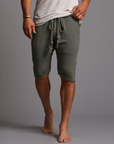 A man modeling urban forest green milanos mid shorts