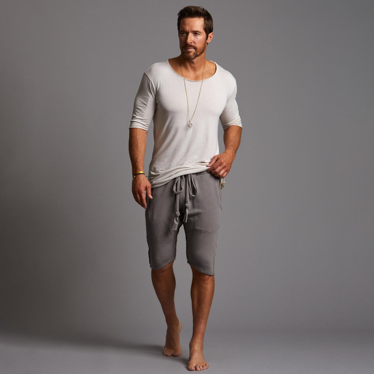 A man modeling deep clay gray milanos mid shorts
