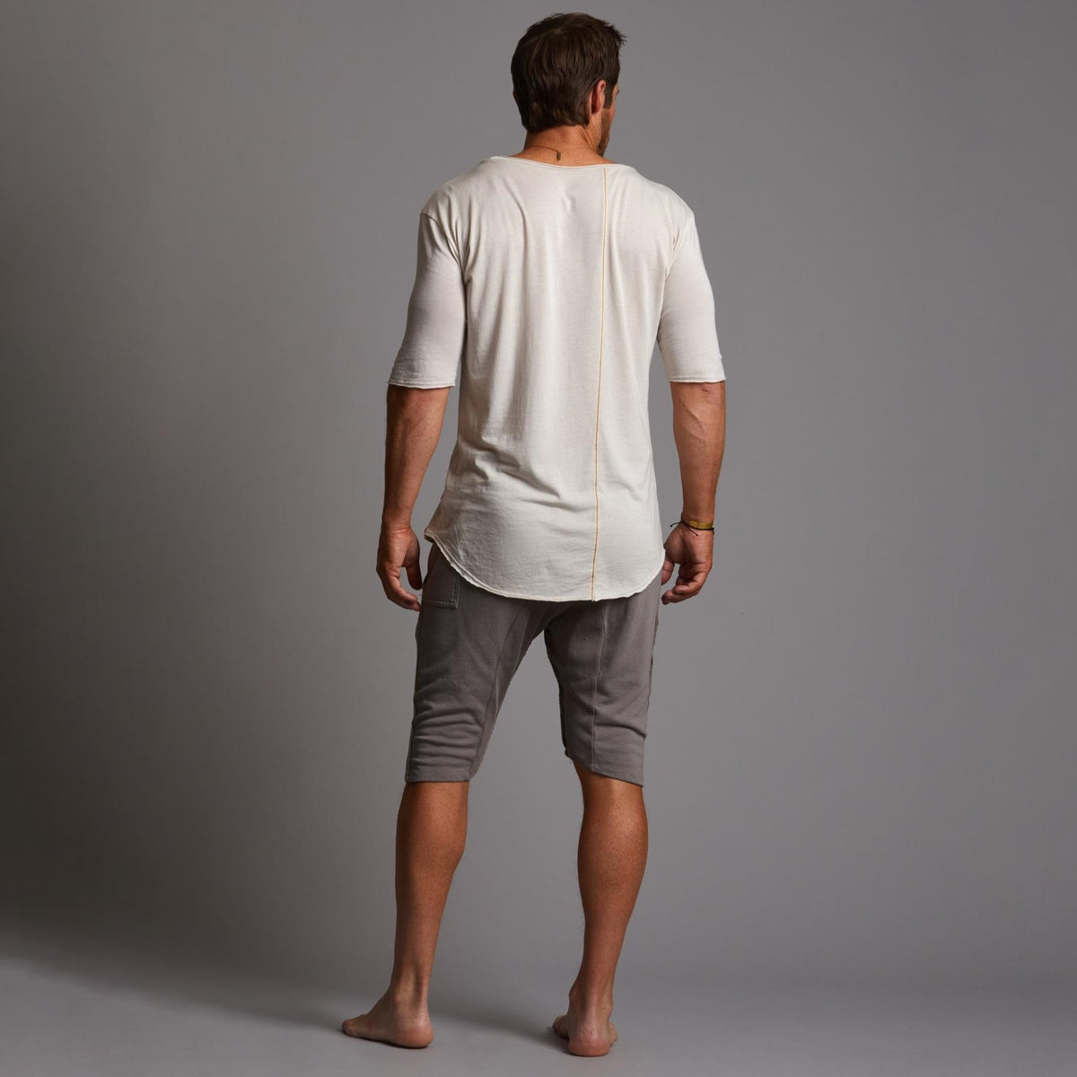 A man modeling deep clay gray milanos mid shorts