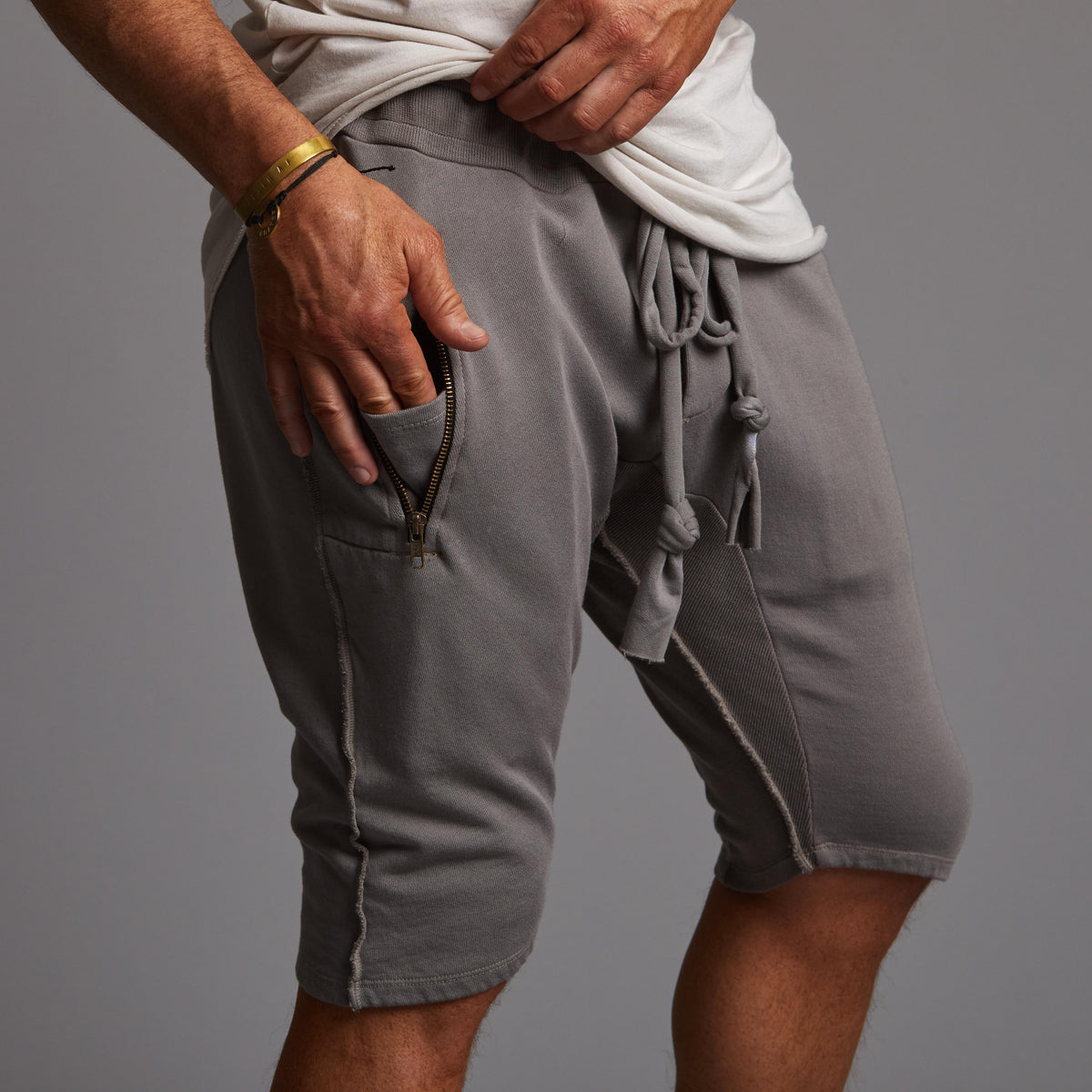 A man modeling deep clay gray milanos mid shorts