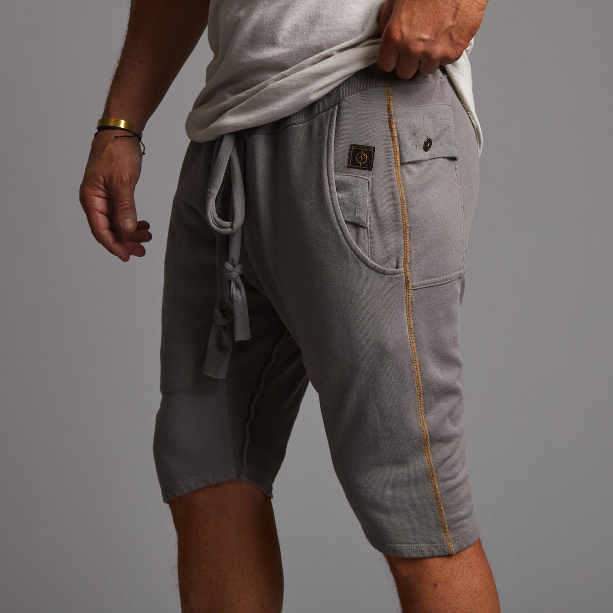 A man modeling deep clay gray milanos mid shorts