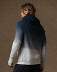 a male modeling the pullover plush hoodie in a blue gradient