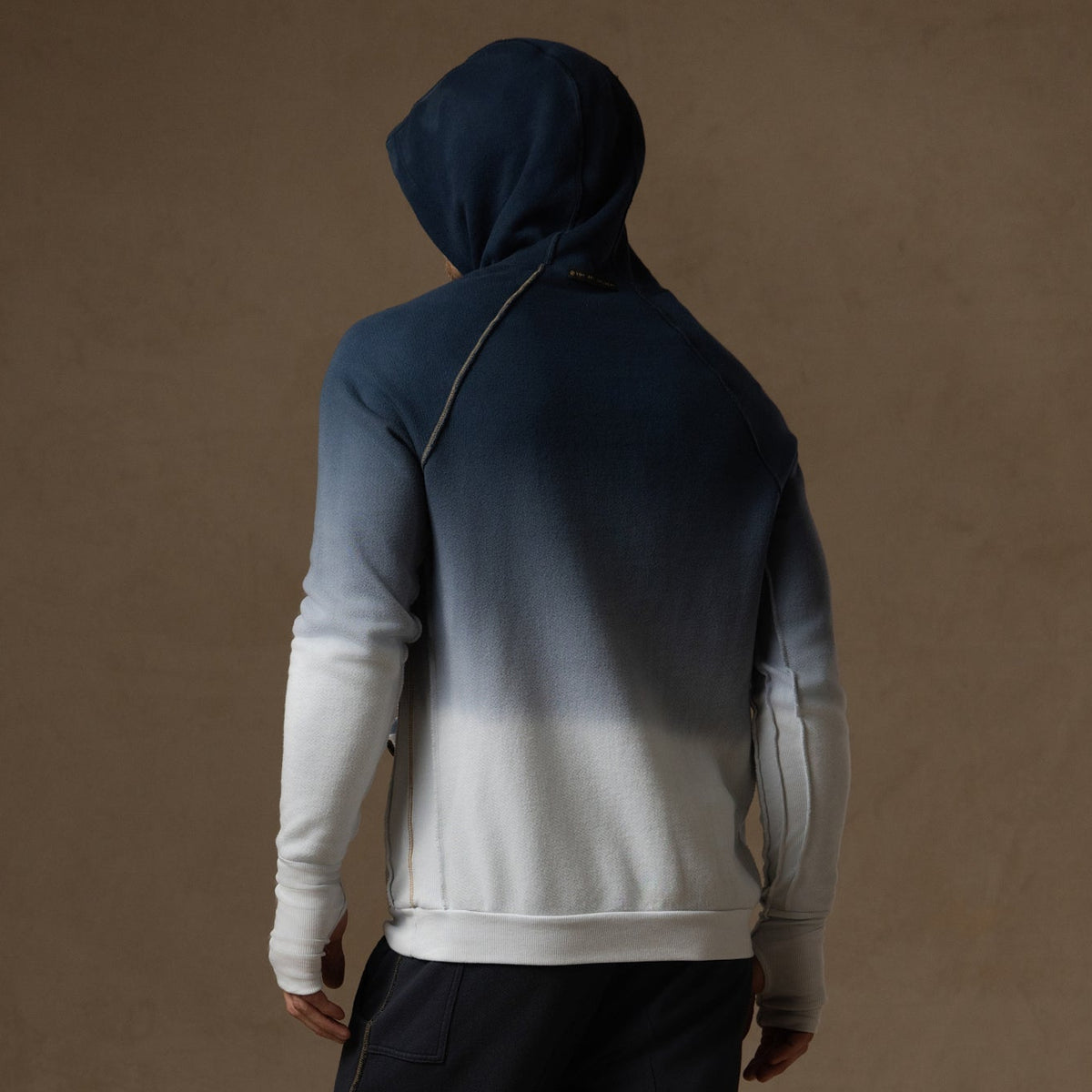 a male modeling the pullover plush hoodie in a blue gradient
