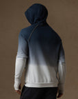 a male modeling the pullover plush hoodie in a blue gradient