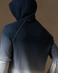 a male modeling the pullover plush hoodie in a blue gradient