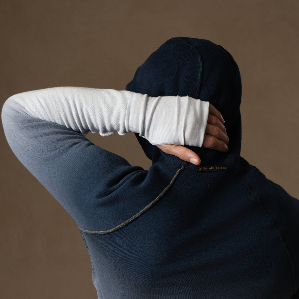 a male modeling the pullover plush hoodie in a blue gradient