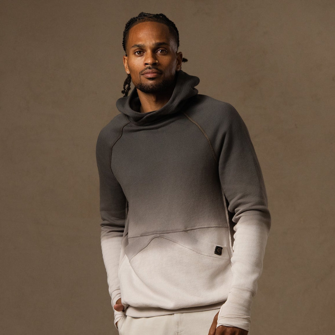 a male modeling the pullover plush hoodie in a grey gradient
