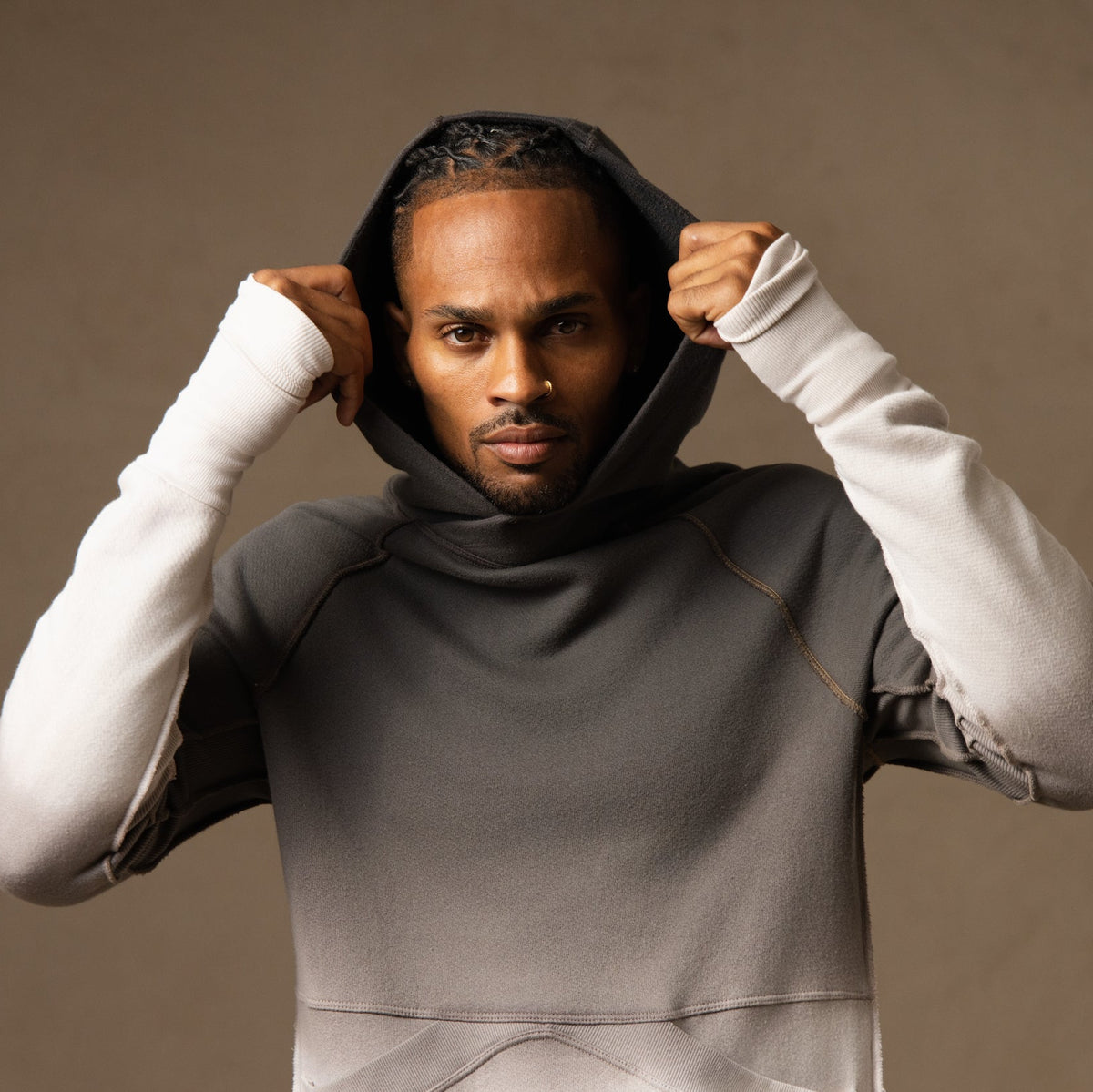 a male modeling the pullover plush hoodie in a grey gradient