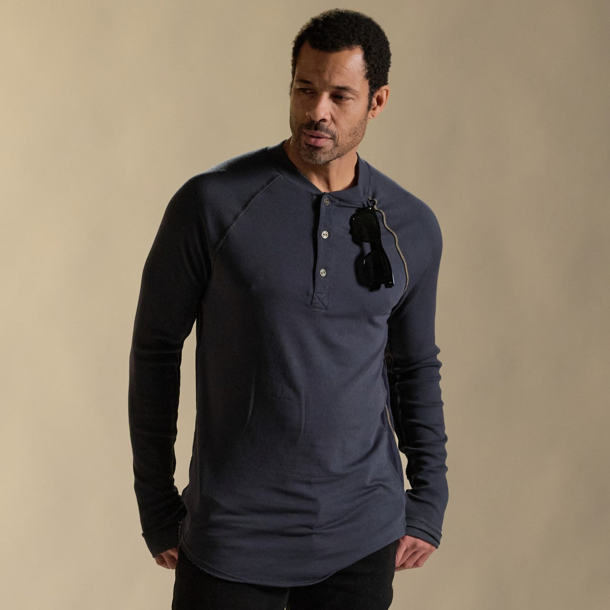 Male modeling blue long sleeve henley